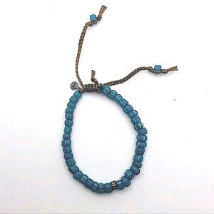 Tai bracelet with tan rope and blue striped beans